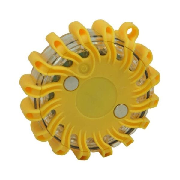 Yellow, circular, battery-powered LED emergency flare with a central button and radial light-emitting segments.