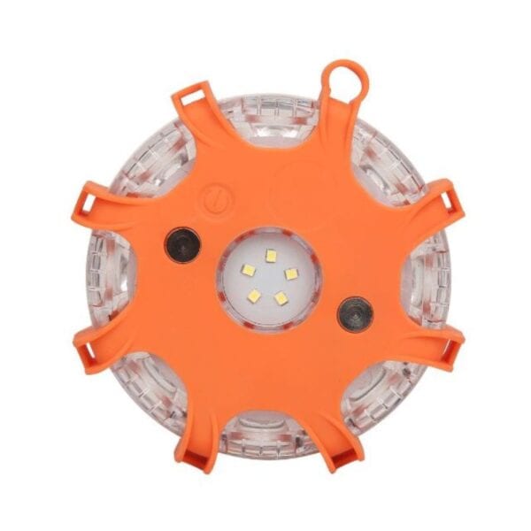 A round orange LED safety light with black rubber grips and multiple small center LEDs.