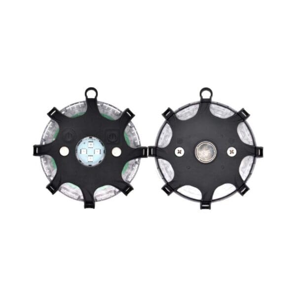 Two circular black devices with multiple attachment points. The front has electronic components; the back features a central component and screws.