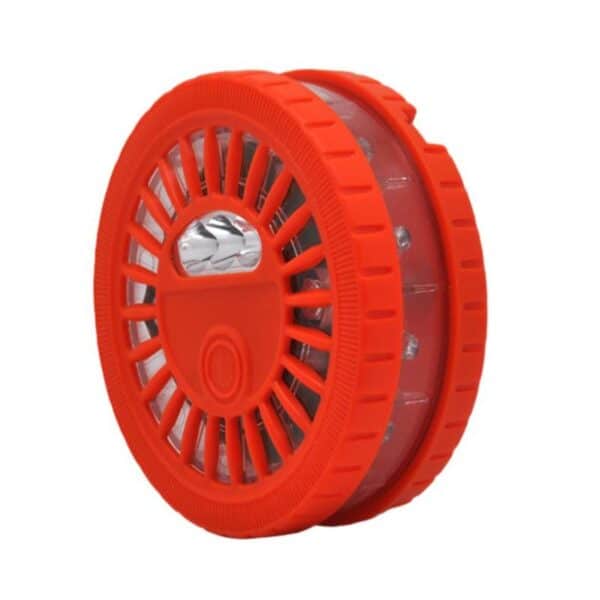 Red circular LED road flare with plastic casing and central button.