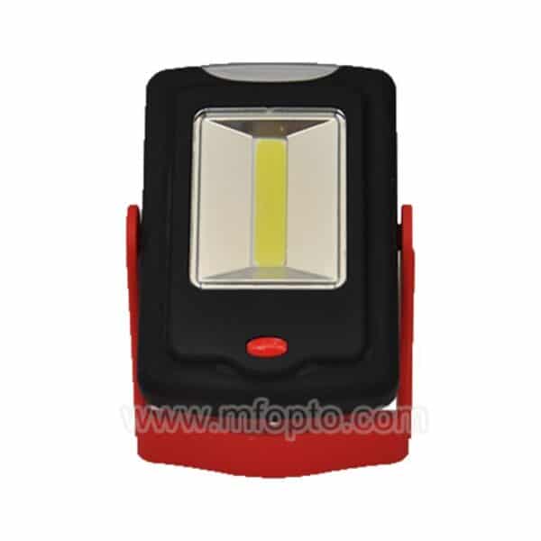 A small rectangular portable LED work light with a black and red plastic casing, central main LED panel, and a red button below.