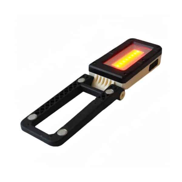 A handheld device with a rectangular screen showing orange lights, attached to a black handle with metallic accents.