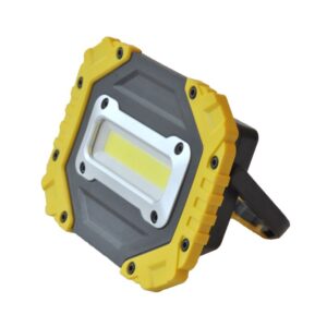 A portable square LED work light with a yellow-gray casing and built-in stand.