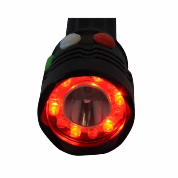 A black handheld device with three buttons (white, green, red) and a front circular lens surrounded by red LED lights.