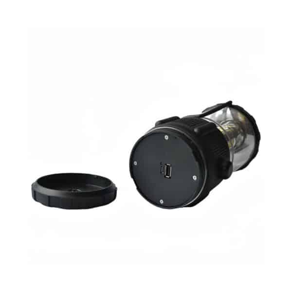 A black portable lantern with a removable lid beside it, revealing the USB port on the bottom.