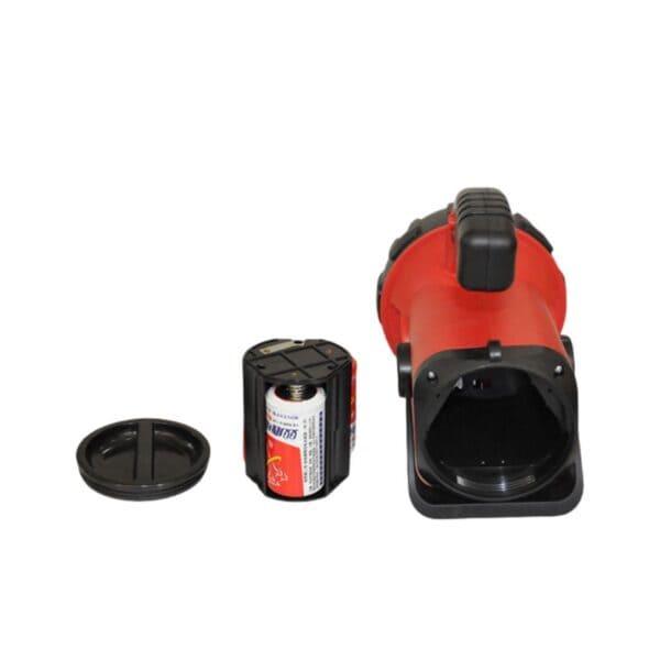 An open red flashlight shows a D battery in the holder; its cap lies next to it.