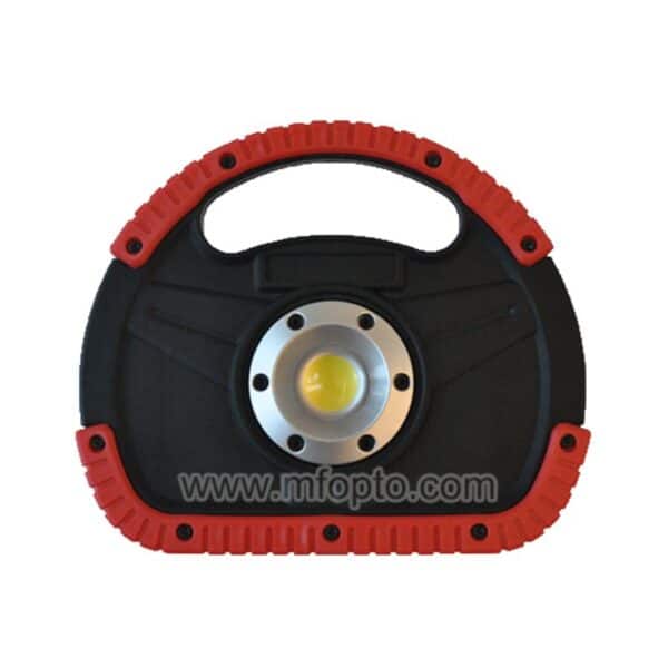 A portable work light with a red handle, ridged grips, and black body with a central LED placed against a plain background.