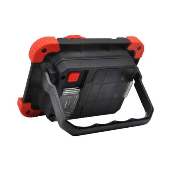A portable LED work light with a black and red casing, handle, and adjustable stand.