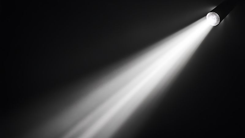 Spotlight LED stage light illuminating a dark background for professional event lighting and stage design.