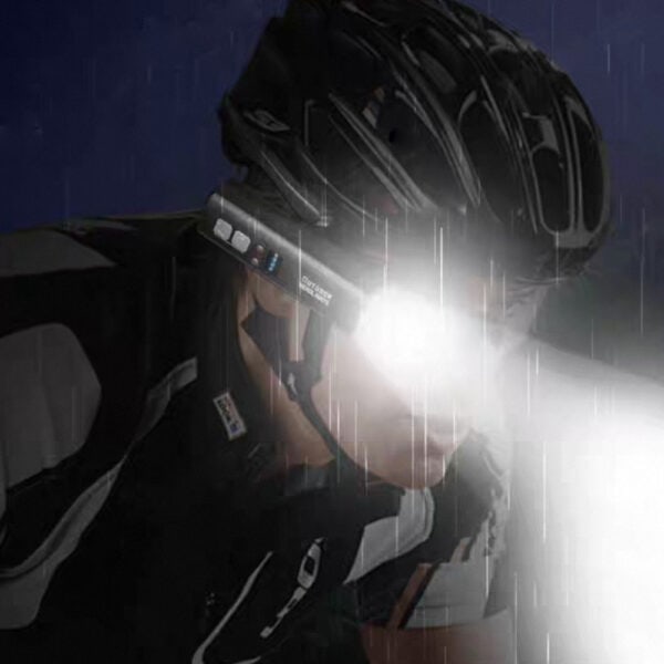 High-performance cyclist wearing a helmet with a mounted light during night ride, showcasing advanced cycling gear and safety equipment for outdoor biking in low-light conditions.