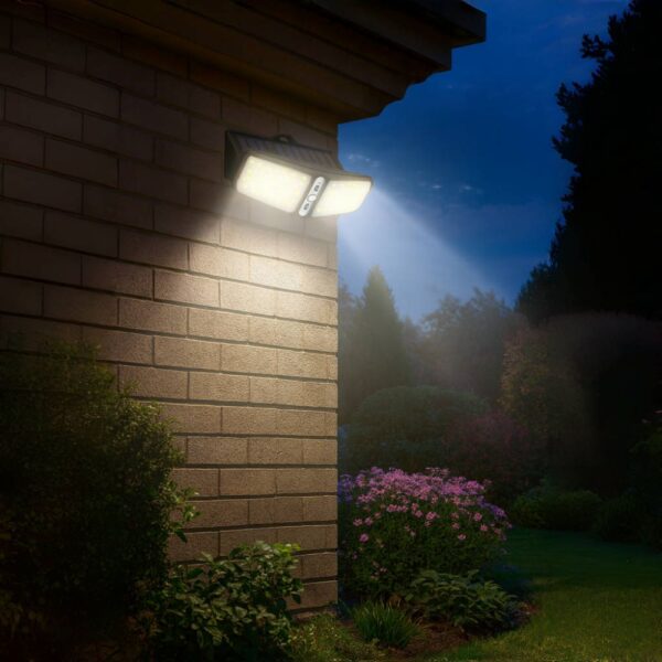 Solar outdoor wall light illuminating brick house wall at night.