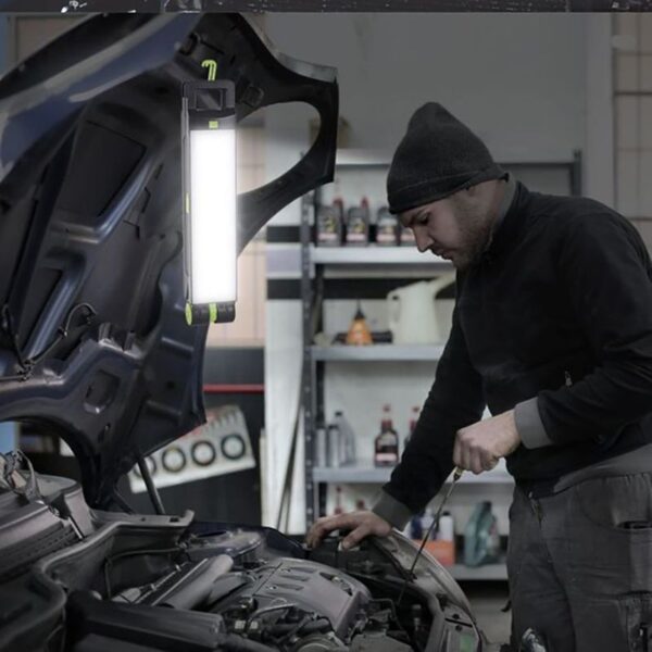 Professional auto mechanic inspecting car engine in garage, car maintenance, vehicle repair, engine diagnostics, automotive service, M&F auto repair, skilled technician working on vehicle.